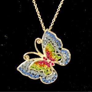 Silver butterfly pendant with colored stones.